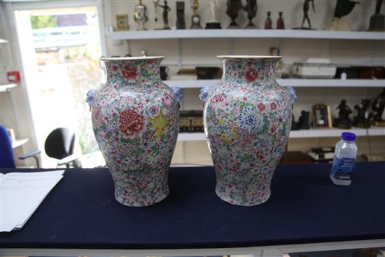 A pair of Chinese thousand flower baluster vases, Republic period, height 40cm excl. wood stands